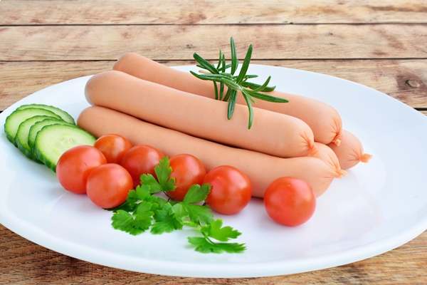 sausages vegetables over wooden table white plate 54481425